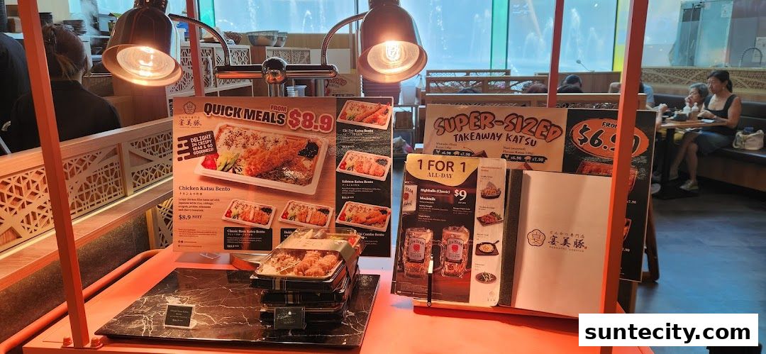 A display of Japanese bento boxes and promotional flyers for Tonkatsu ENbiton.