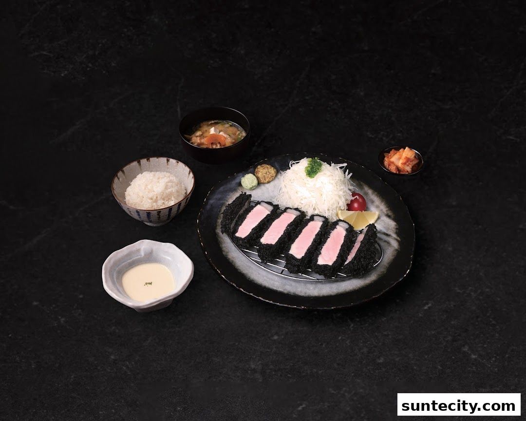 A delicious Tonkatsu meal with rice, soup, and side dishes on a dark background.