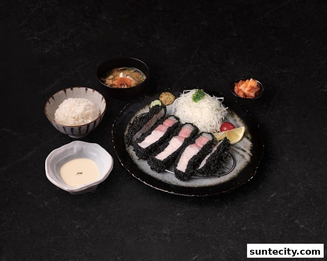 A delicious meal featuring crispy pork cutlets, rice, soup, and kimchi.