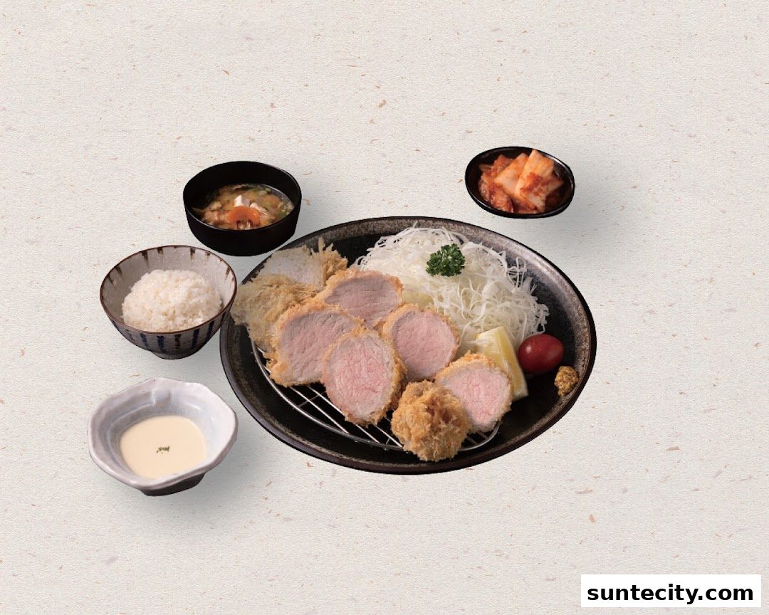 A delicious Tonkatsu set meal with rice, soup, kimchi, and dipping sauce.