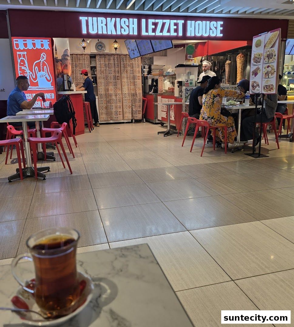 The Turkish Lezzet House shop front with customers dining and a kebab grill visible.