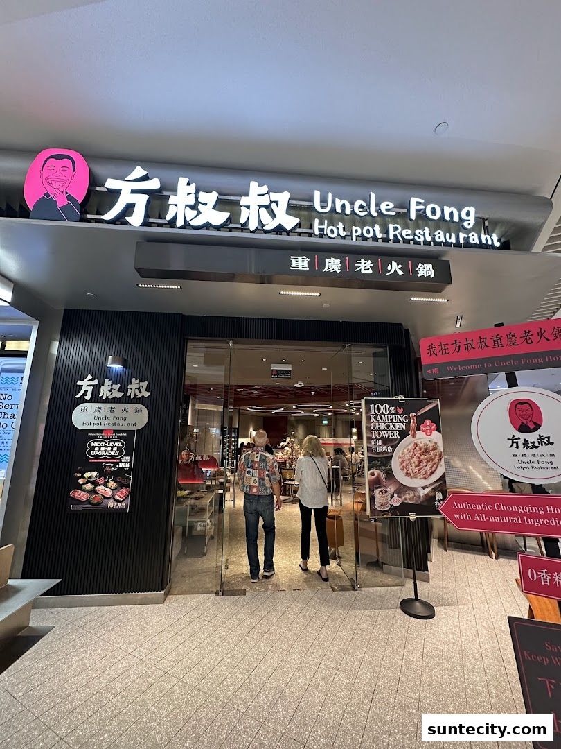 The entrance of Uncle Fong Hotpot Restaurant, featuring its prominent signage and inviting glass doors.
