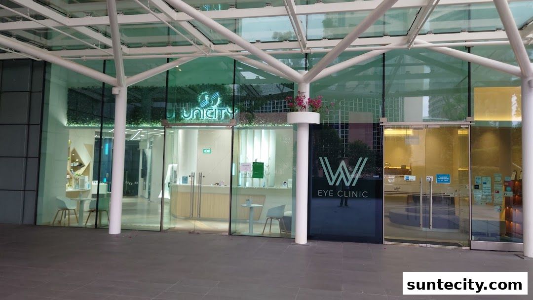 The modern storefront of Unicity and W Eye Clinic features glass facades and clean signage.
