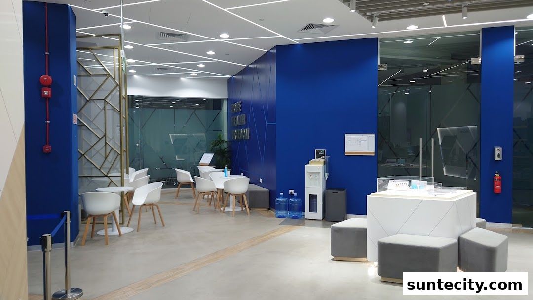 Modern interior of Unicity with blue walls, seating area, and display counter.