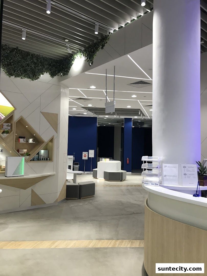 Interior view of a modern retail space with a reception desk and seating area.