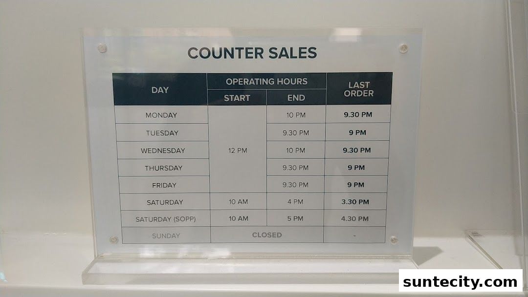 A sign displaying counter sales operating hours for Unicity.