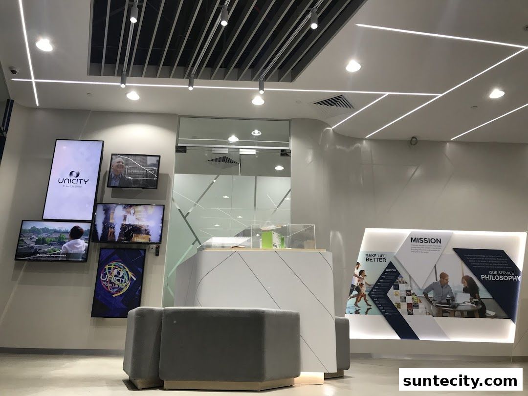 Interior view of a modern Unicity shop with digital displays and a reception desk.
