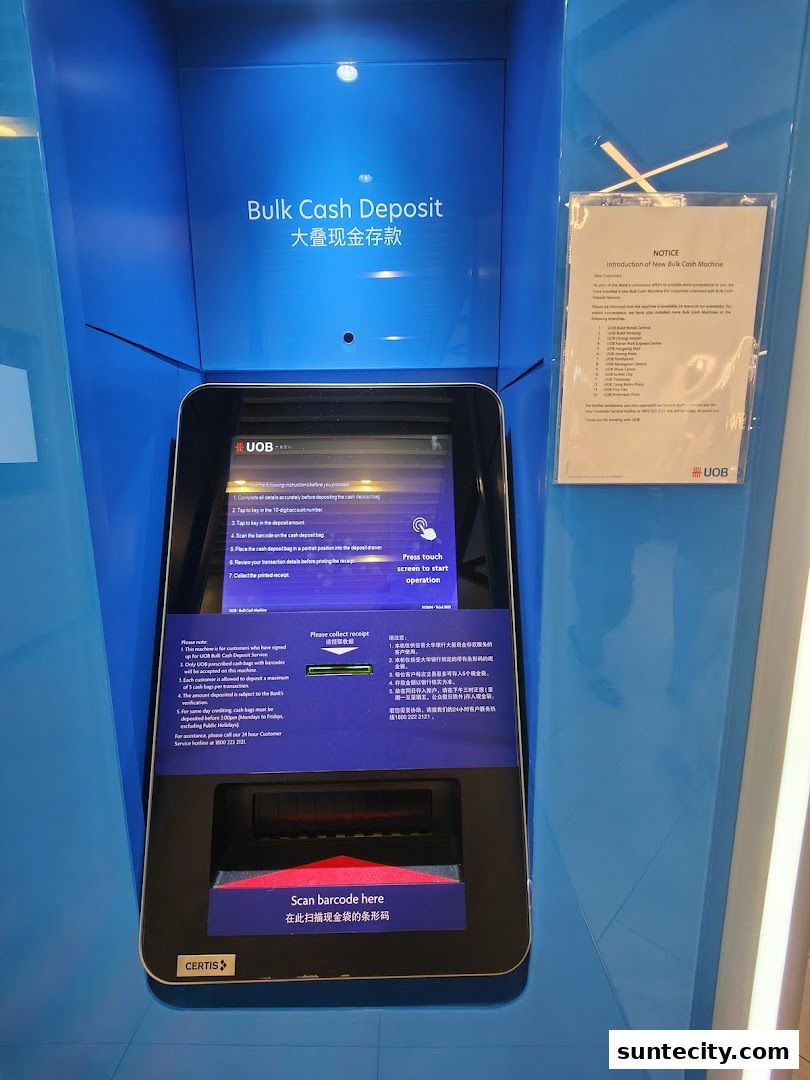 A UOB bulk cash deposit machine with instructions and a notice.