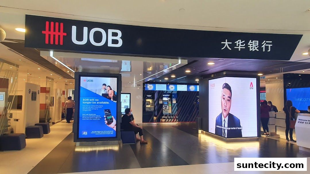 The entrance of a UOB bank branch with digital displays and ATMs visible.