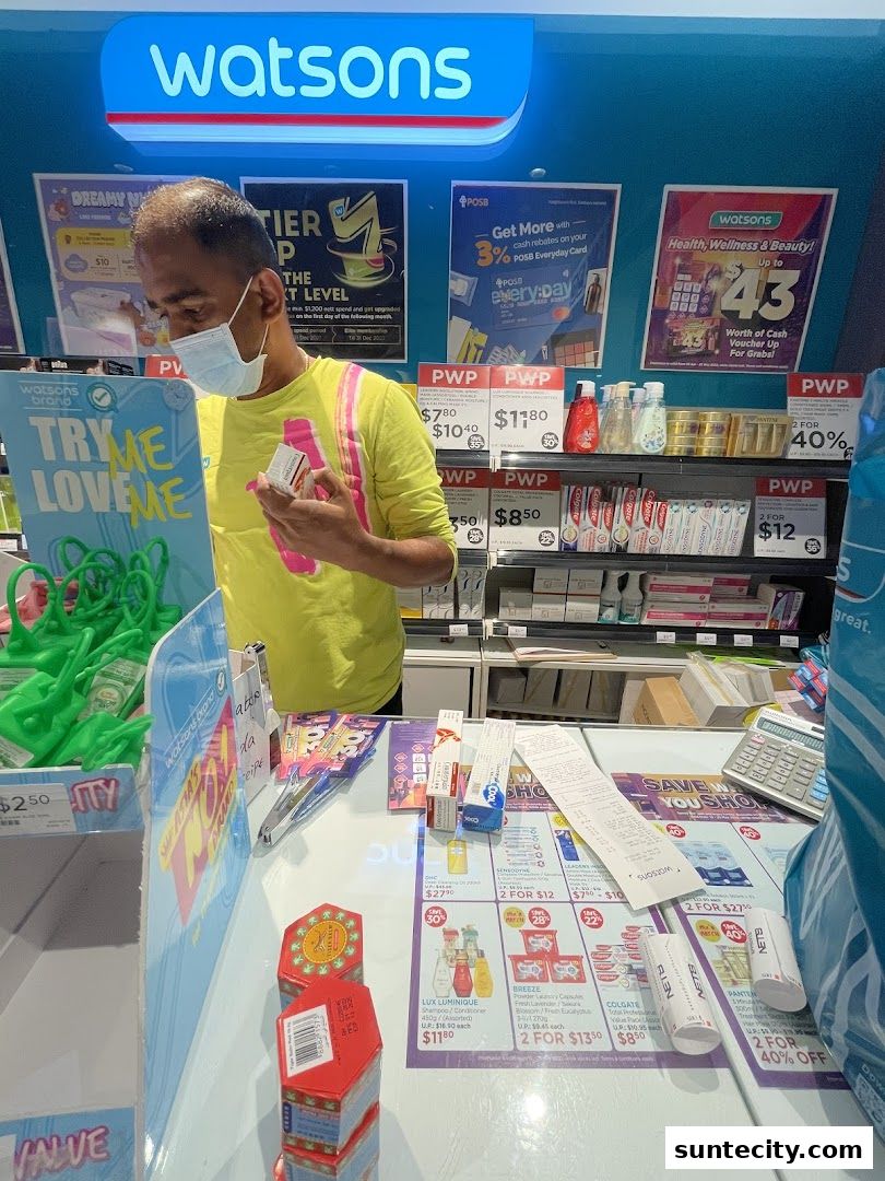A Watsons store interior with a customer and various health and beauty products on display.
