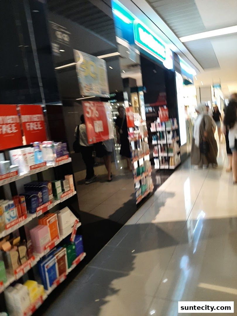 A Watsons pharmacy and GNC store front with shelves of health and beauty products.