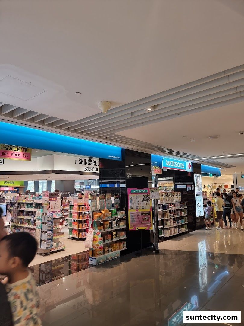 Interior view of a Watsons pharmacy and GNC store with shelves stocked with products.