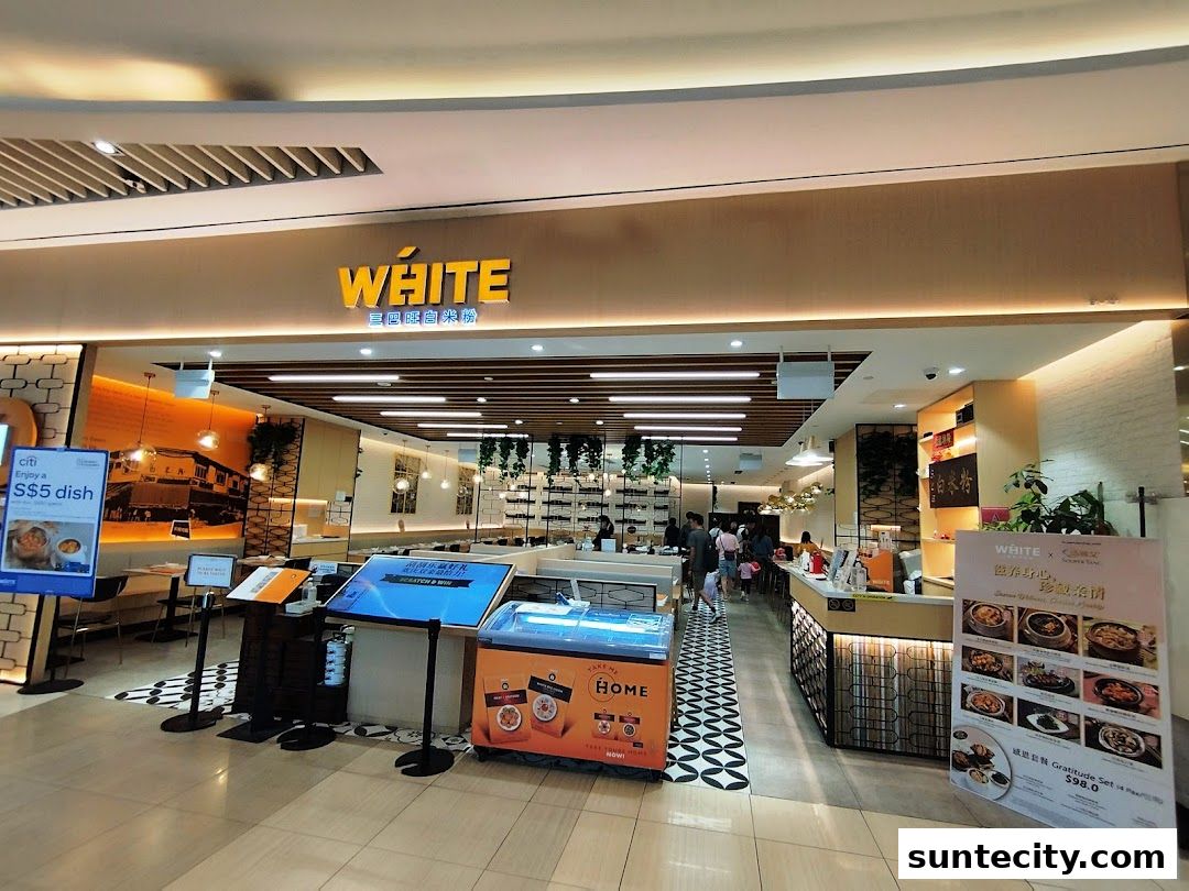 The entrance of White Restaurant Suntec City, showcasing its modern interior and promotional displays.