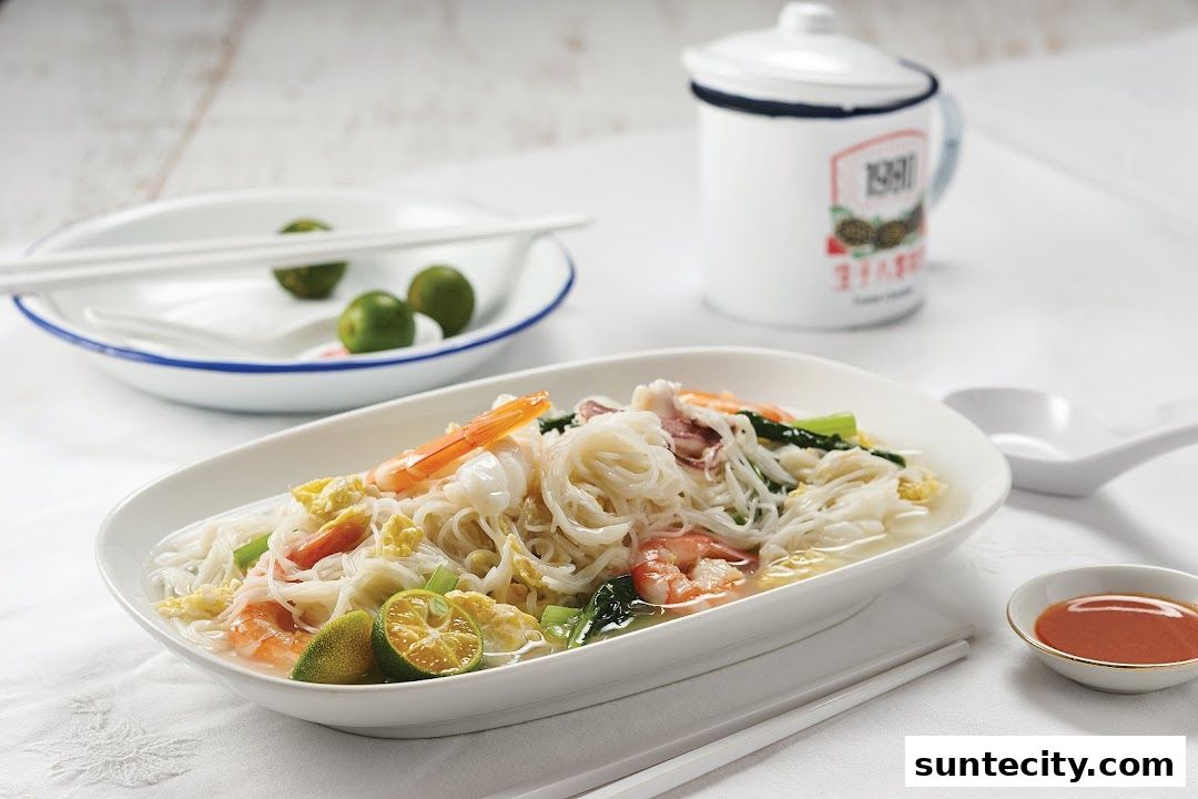 A close-up of a delicious seafood noodle dish with shrimp, squid, and lime.
