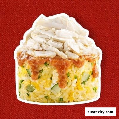A close-up of a serving of fried rice topped with shredded crab meat and sauce.