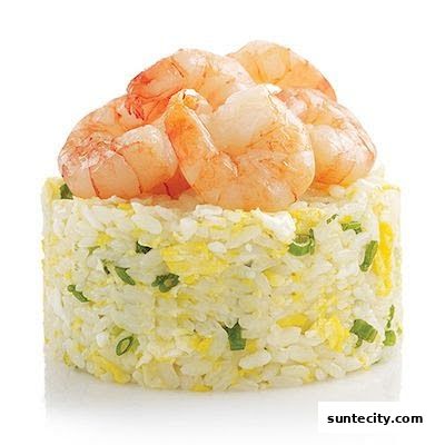 A serving of shrimp fried rice with chopped scallions and scrambled egg.