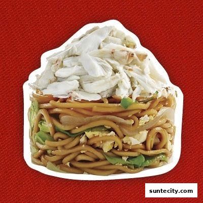 A close-up of a noodle dish topped with generous amounts of crab meat.