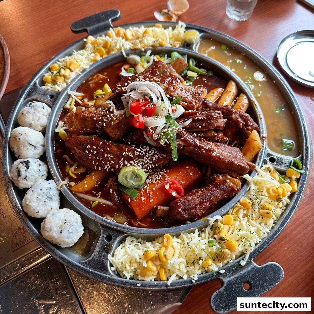 A delicious Korean braised ribs dish with rice balls and corn cheese.