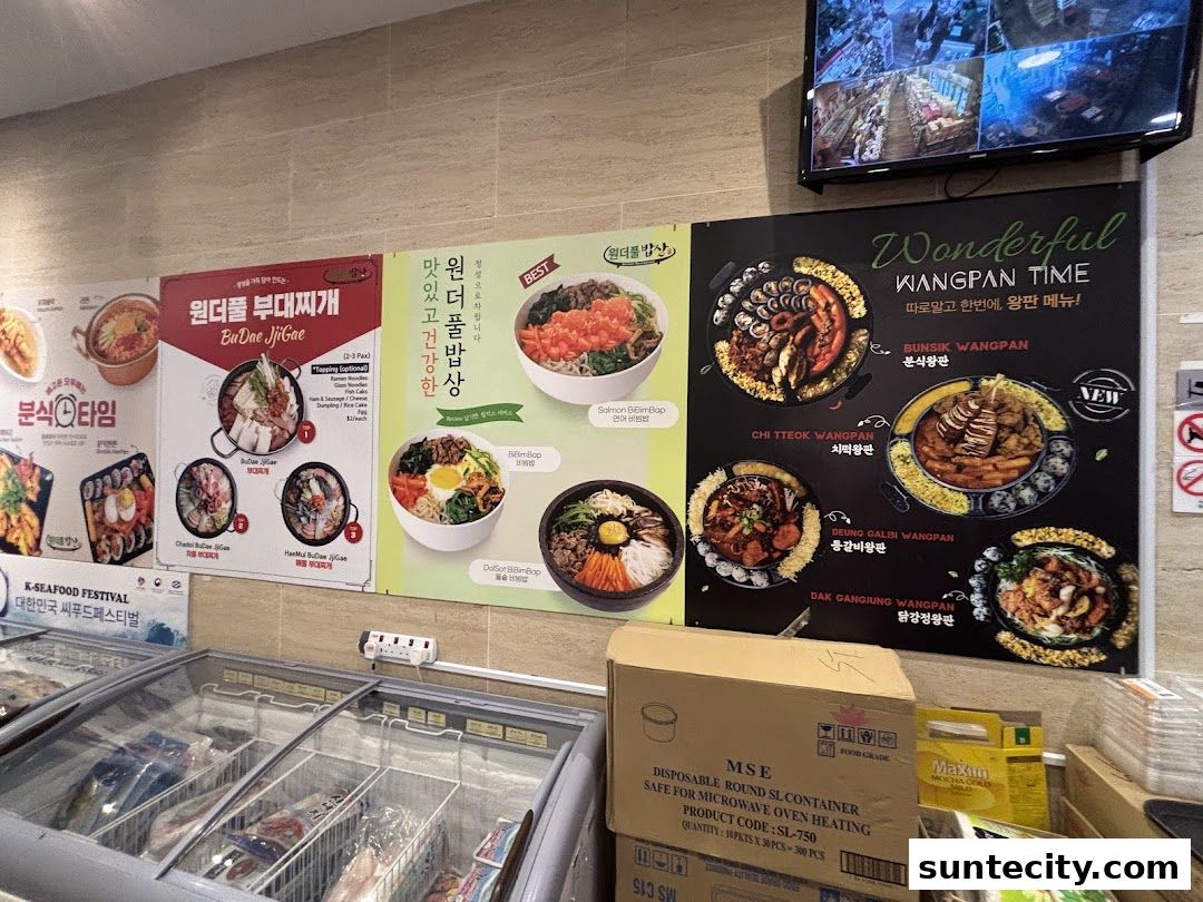 A wall display showcasing Korean food dishes with vibrant images and text.