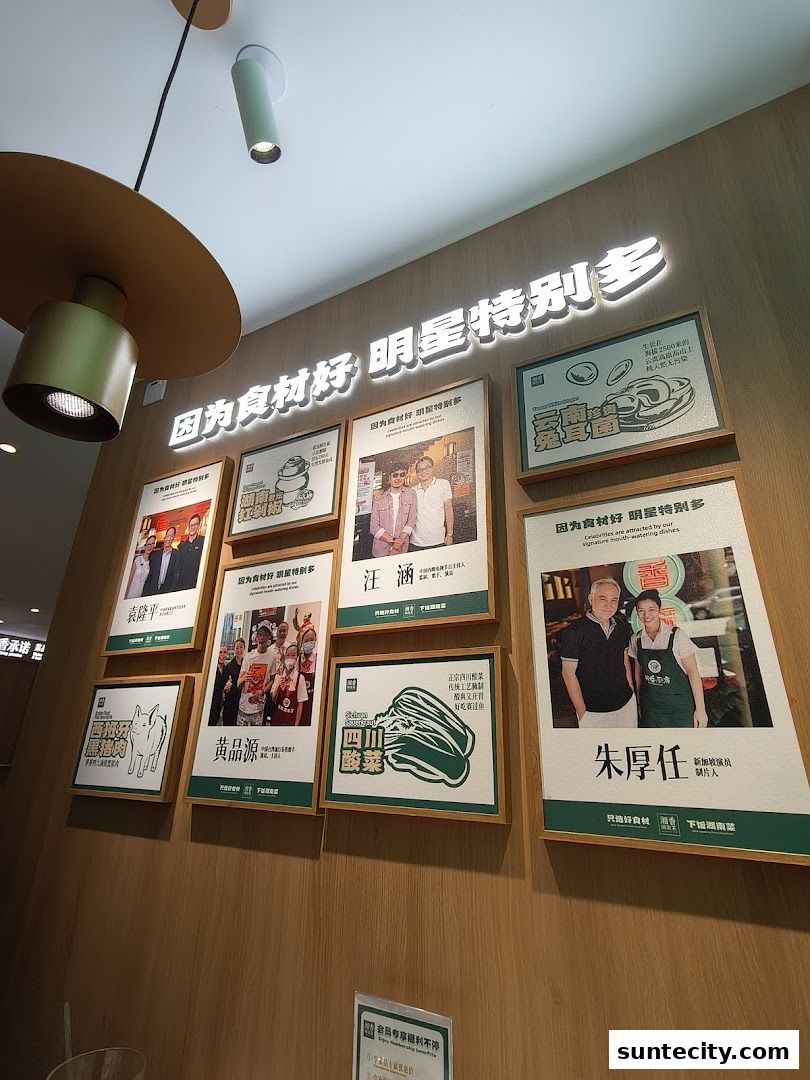 Wall display featuring framed photos and text, likely promoting celebrity endorsements for a restaurant.