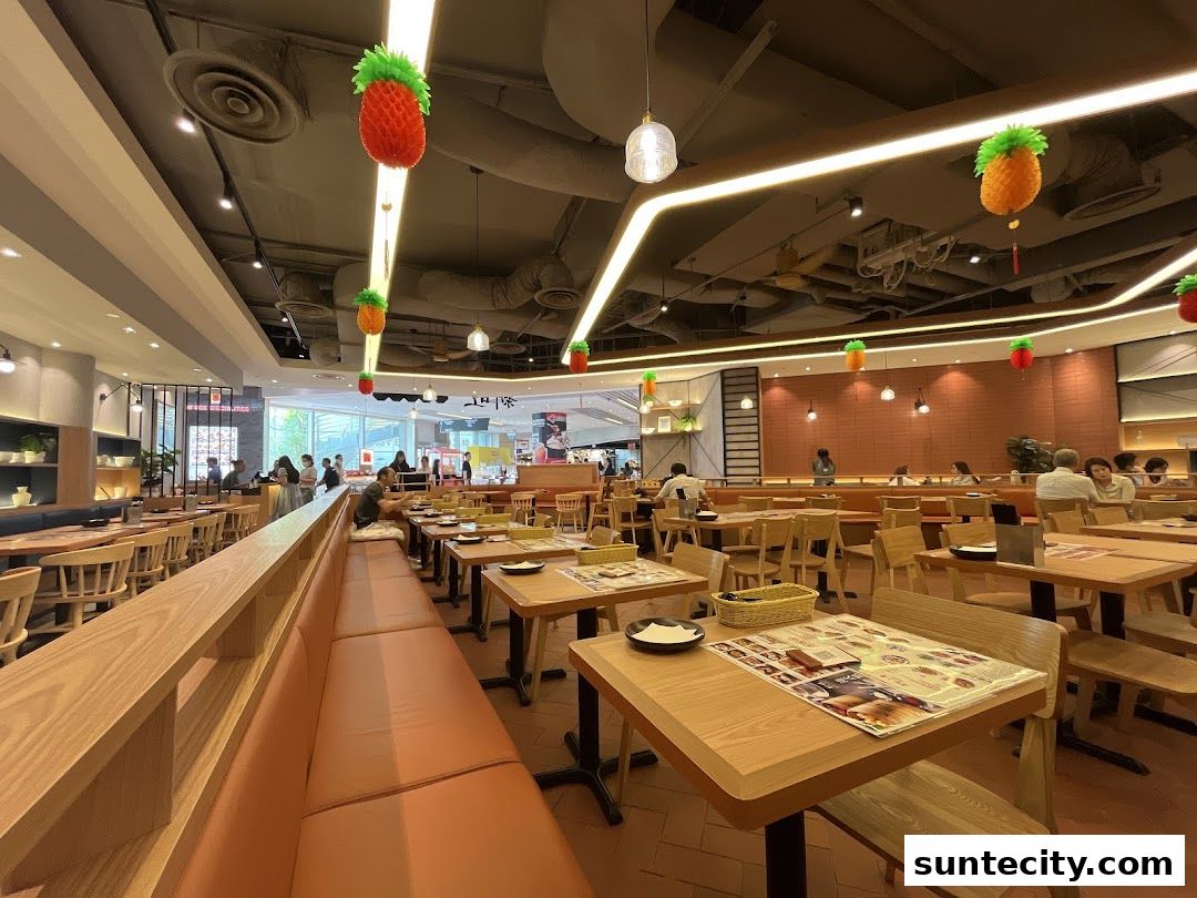 Interior view of a Hong Kong-style cafe with seating and decorative fruit ornaments.