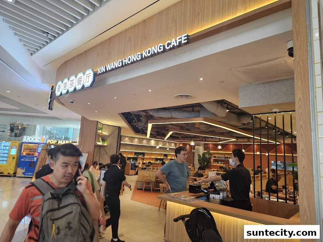The entrance of Xin Wang Hong Kong Cafe with customers and staff visible inside.