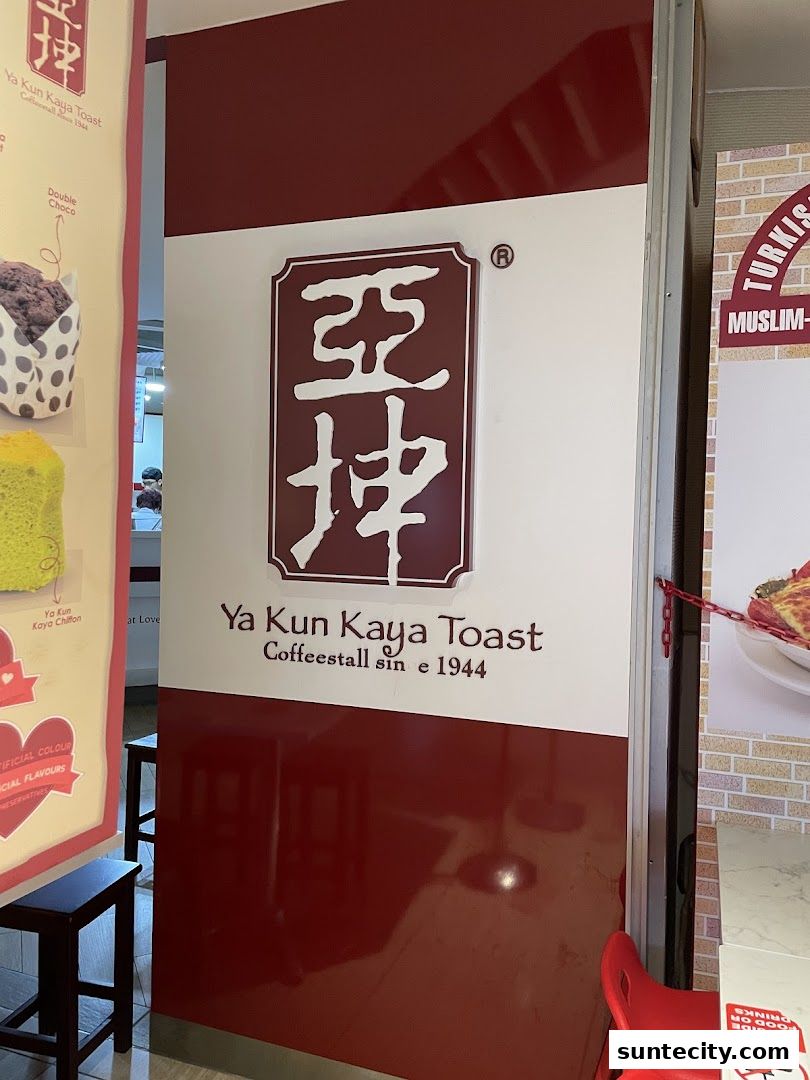 The entrance to Ya Kun Kaya Toast, a coffee stall established in 1944, with its logo and branding visible.
