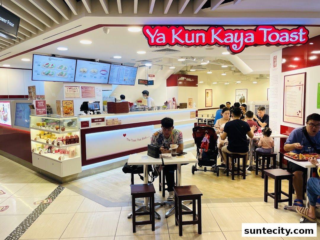 Interior view of Ya Kun Kaya Toast with customers dining and staff serving at the counter.
