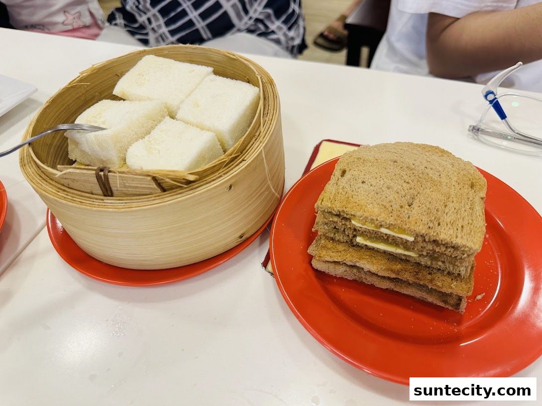 A close-up of Ya Kun Kaya Toast's signature kaya toast and steamed bread.