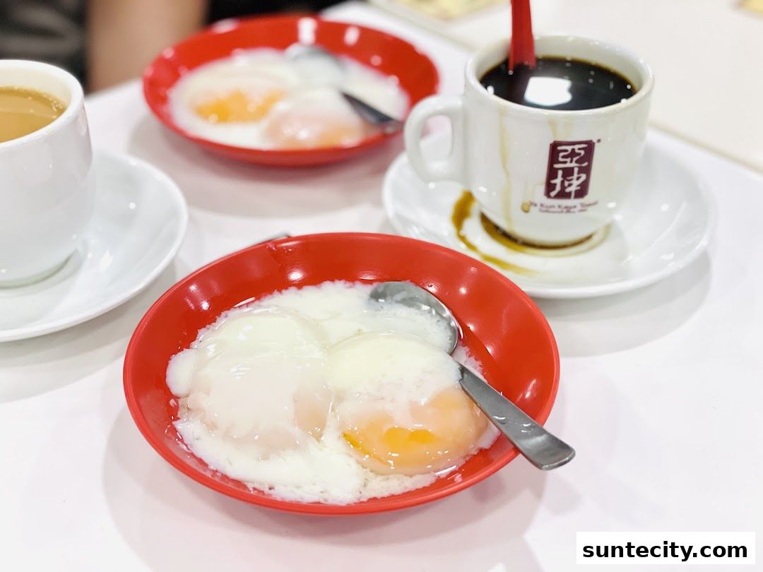 A close-up of soft-boiled eggs and coffee at Ya Kun Kaya Toast.