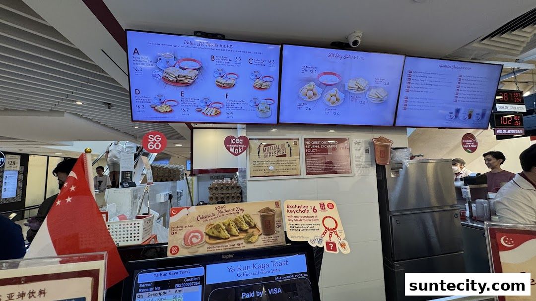 A Ya Kun Kaya Toast counter with digital menus displaying food and drink options.