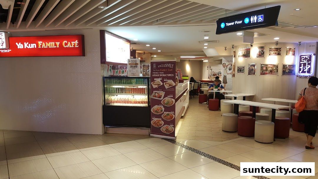 The interior of Ya Kun Kaya Toast Family Cafe with seating and a display fridge.