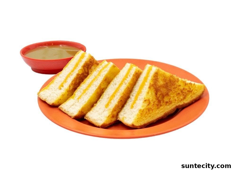 A plate of kaya toast sandwiches served with a side of kaya dip.