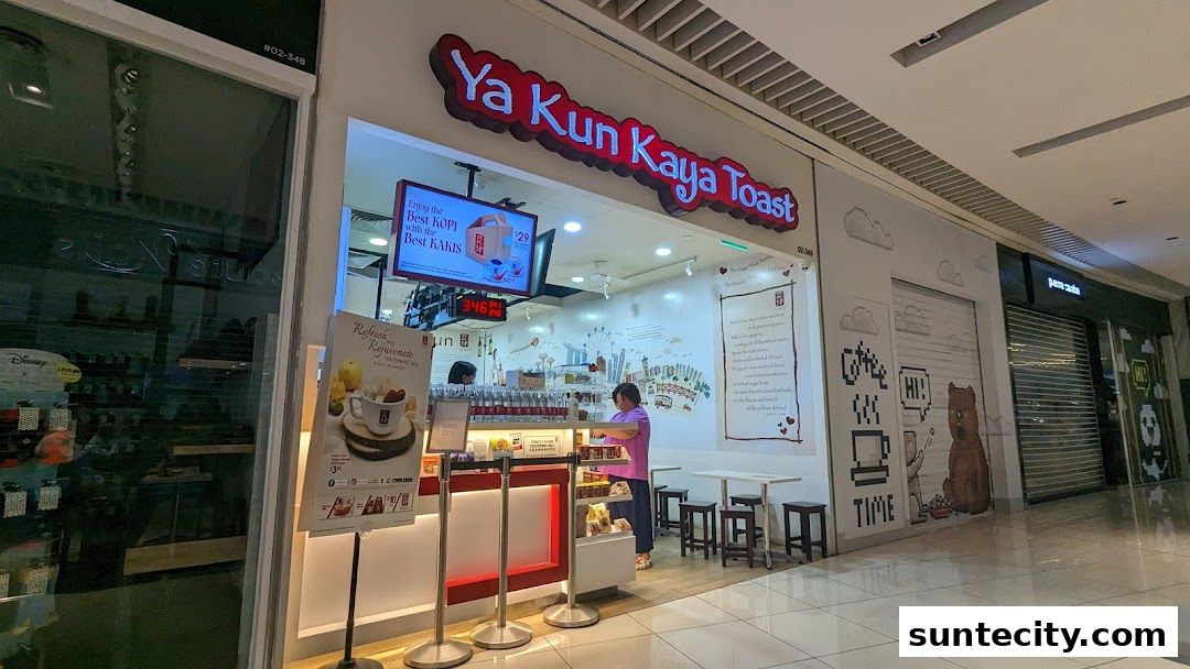 The Ya Kun Kaya Toast shop front with its iconic signage and a display of their popular beverages.
