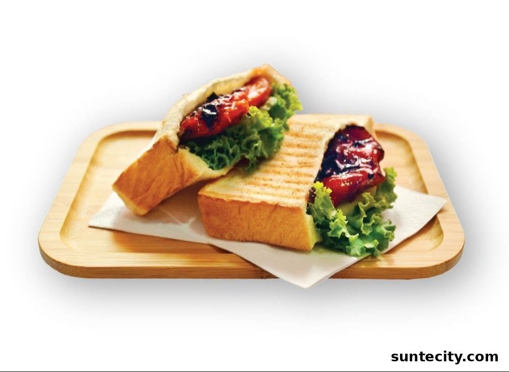 Two halves of a grilled sandwich with lettuce and a savory filling on a wooden tray.