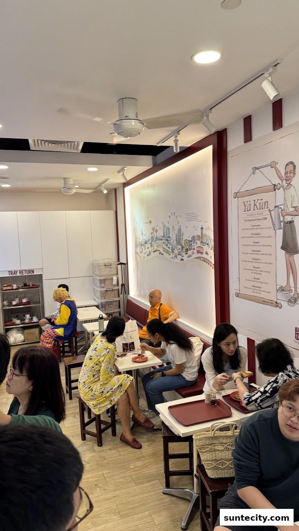 Customers enjoying kaya toast and drinks at Ya Kun Kaya Toast.