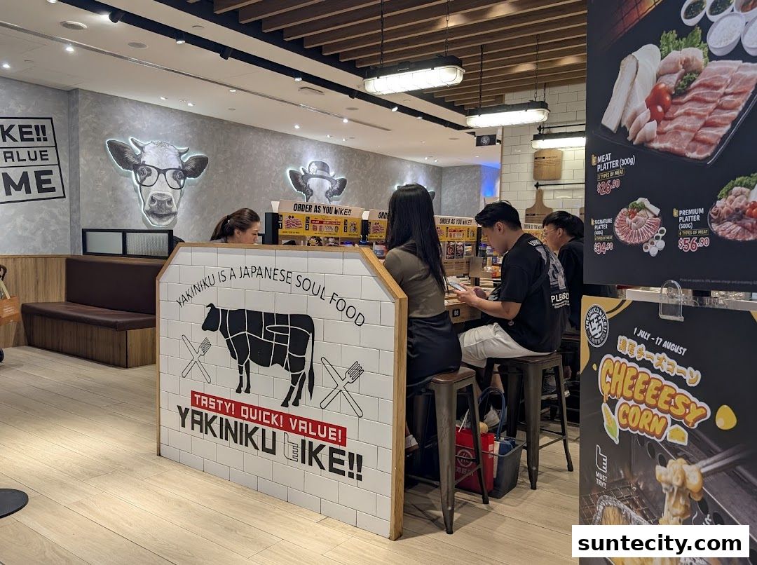 Interior of Yakiniku Like restaurant with customers dining and a menu board displaying meat platters.