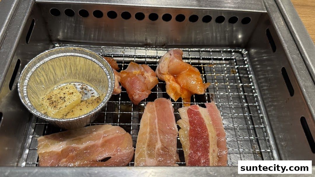 Raw meat and butter with spices on a grill, ready for cooking.