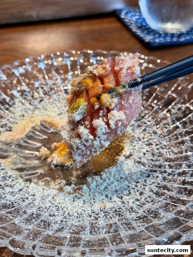 A close-up of a delicious dish with chopsticks picking up a piece of food.