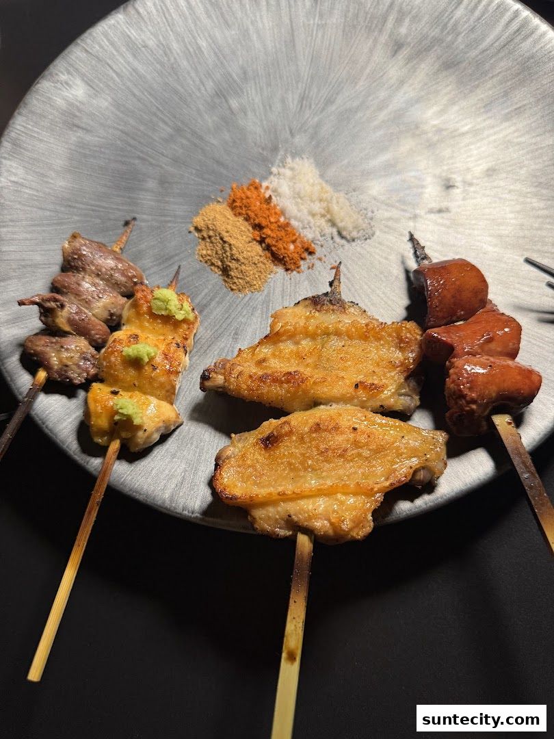 A plate of assorted yakitori skewers with various seasonings.