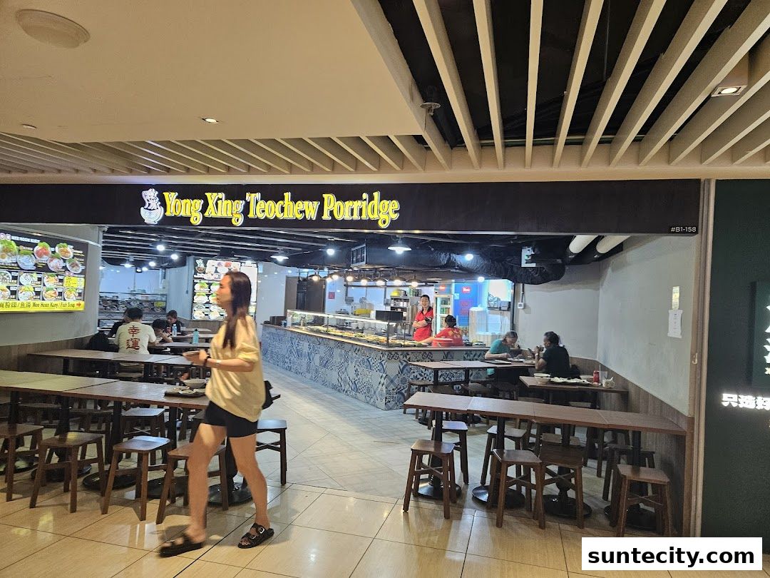 Yong Xing Teochew Porridge shop interior with customers dining and staff serving.