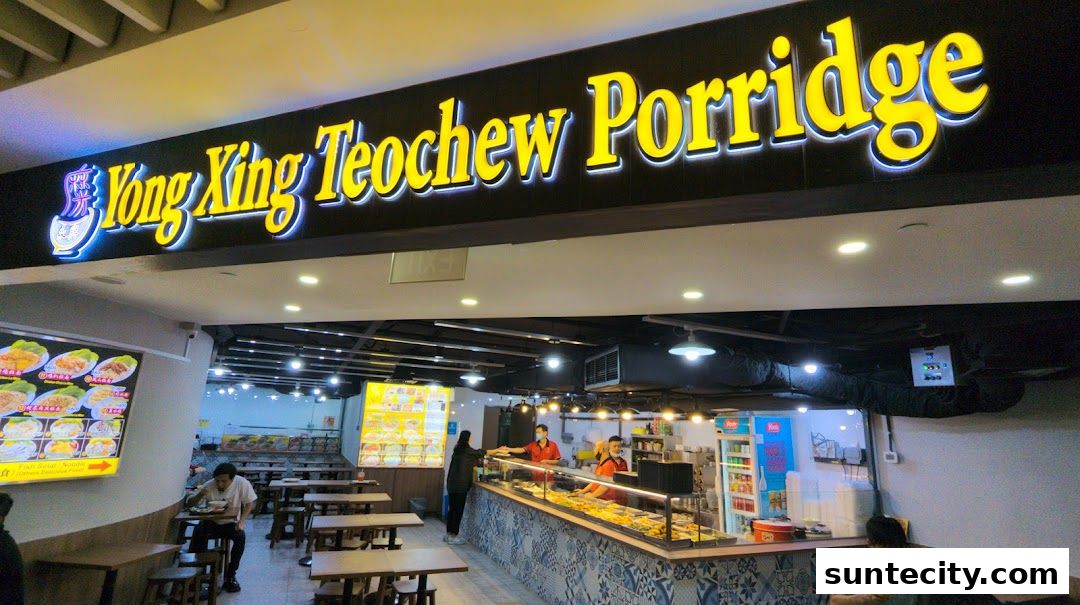 The Yong Xing Teochew Porridge shop front with a bright neon sign and seating area.