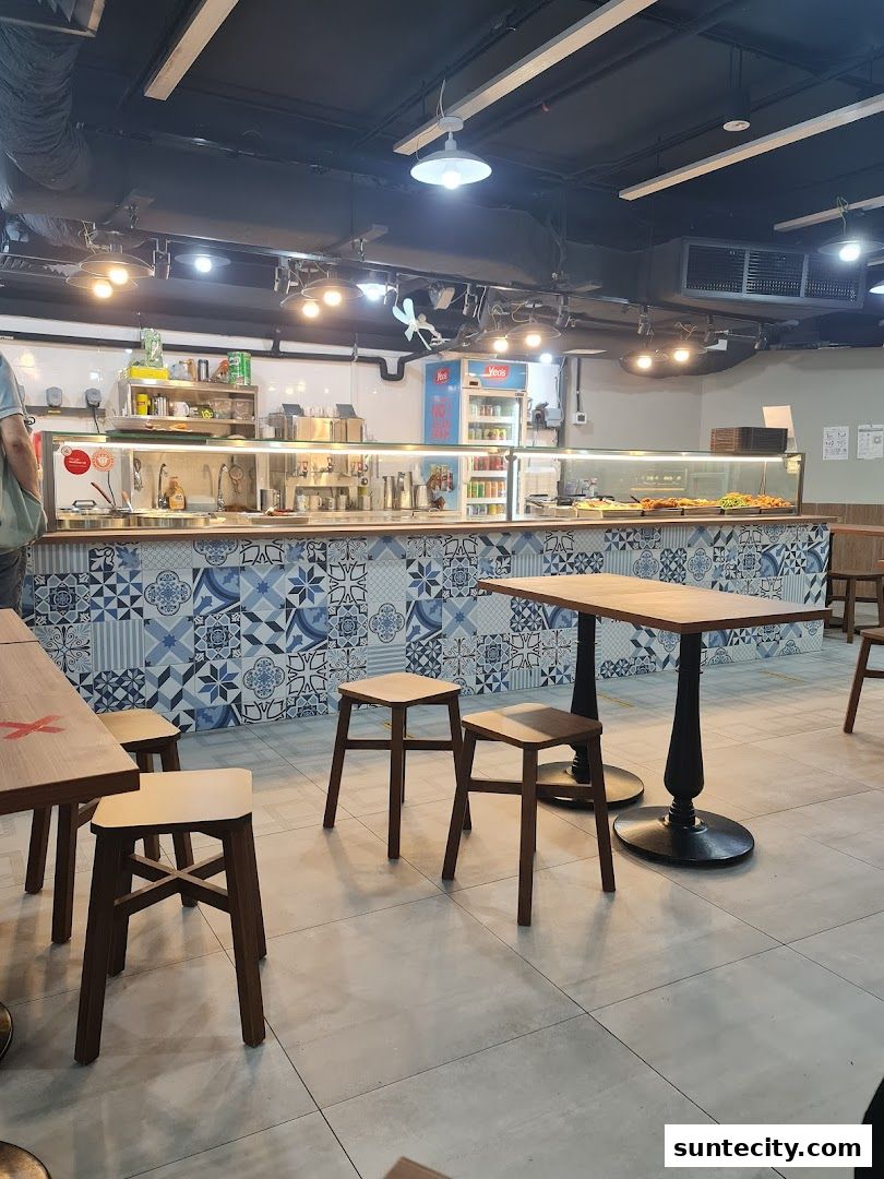 Interior view of Yong Xing Teochew Porridge with seating and food counter.