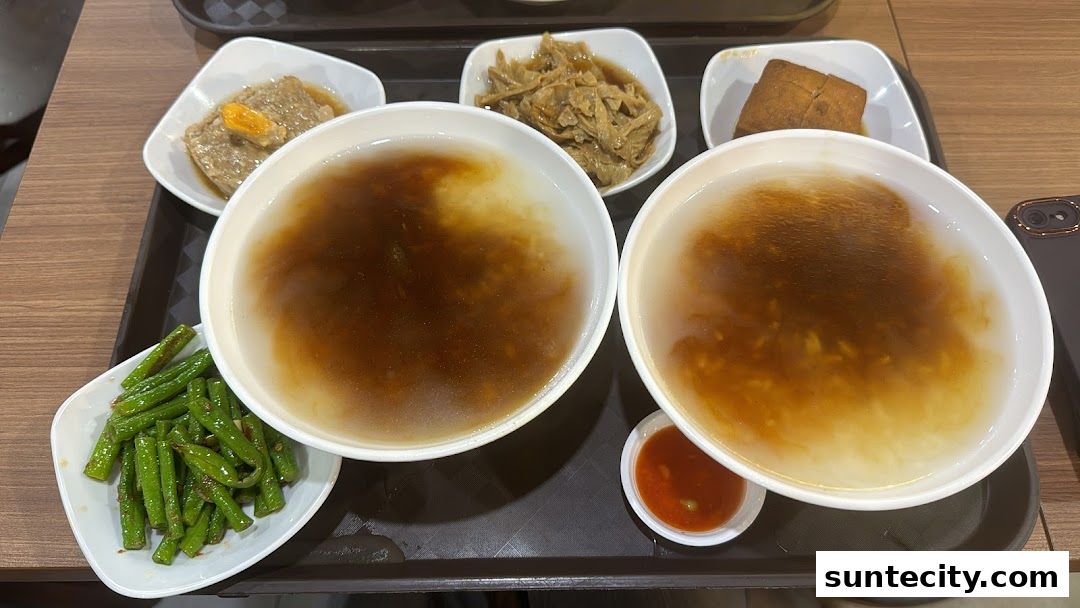 A tray of Teochew porridge with various side dishes and dipping sauce.