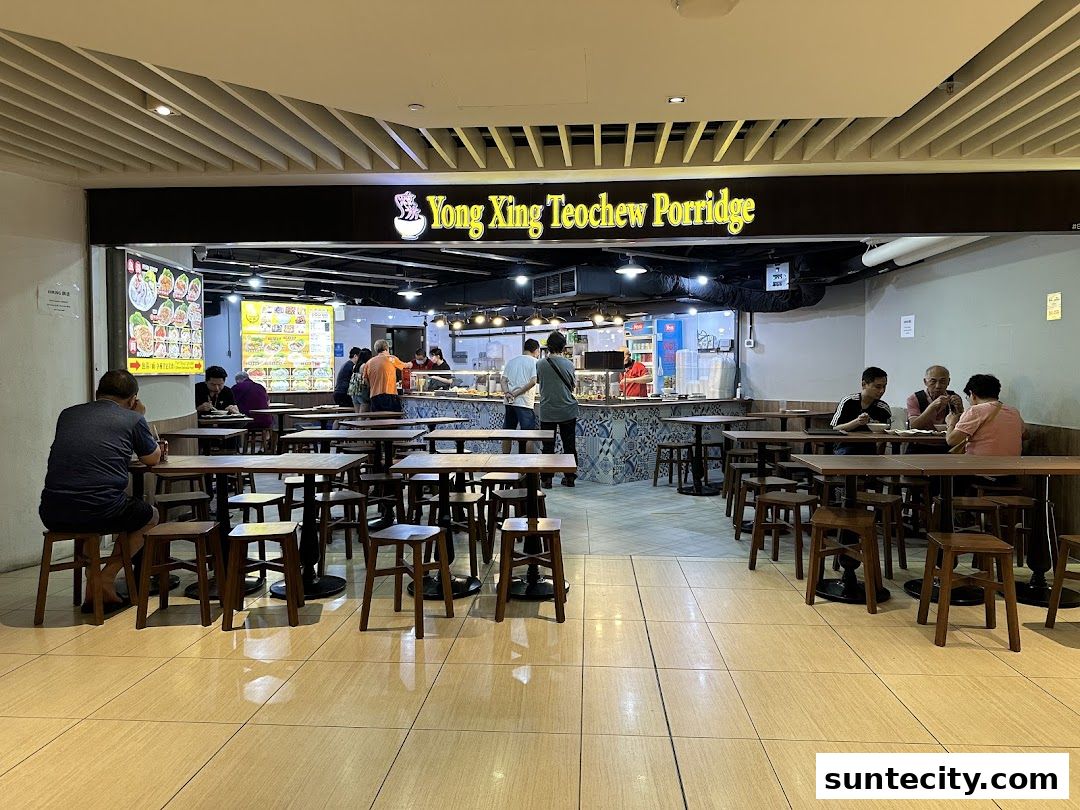 Yong Xing Teochew Porridge shop with customers dining and a display of food items.